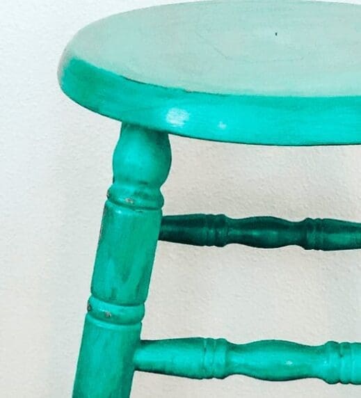 Stool painted in turquoise clay furniture paint and antiqued with dark wax