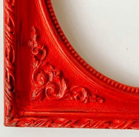 close up of picture frame painted in pomegranate clay paint