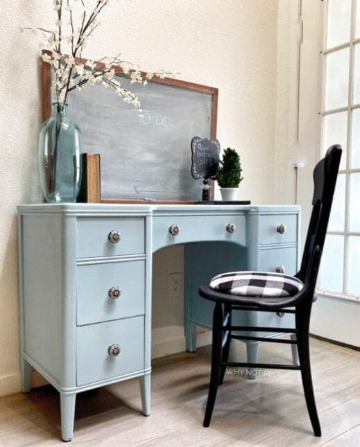 bureau dresser painted in light blue Mudpaint clay furniture paint with black chair