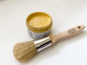 open container of butternut yellow clay furniture paint with mudpaint logo natural bristle brush