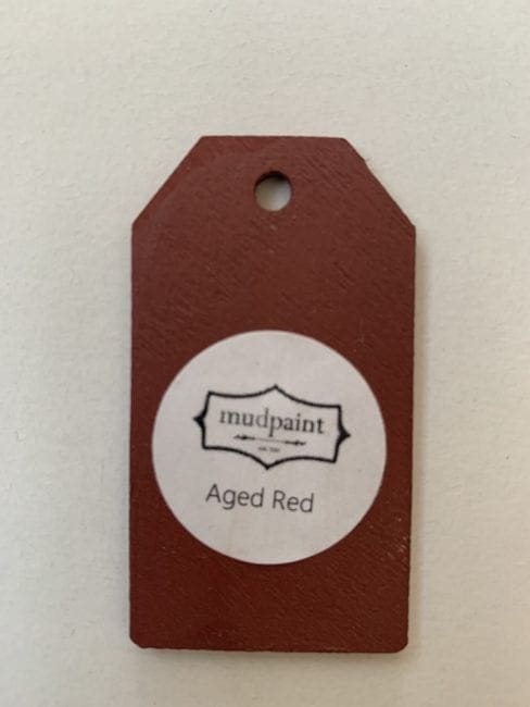 Small wooden tag hand painted with red paint