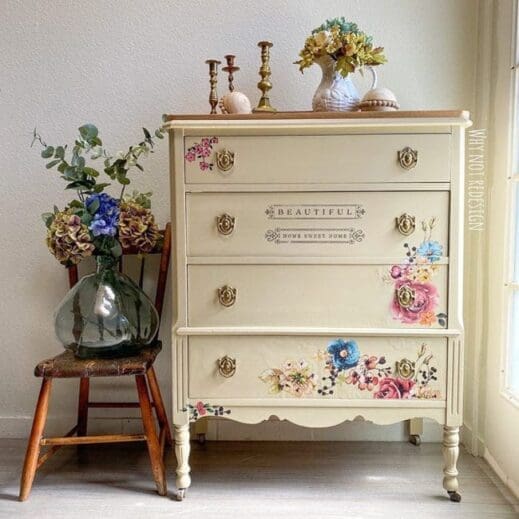 dresser painted in tan clay furntiure paint with flowers and a vase resting beside it