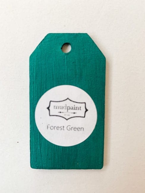 Small wooden tag hand painted with dark green clay furniture paint