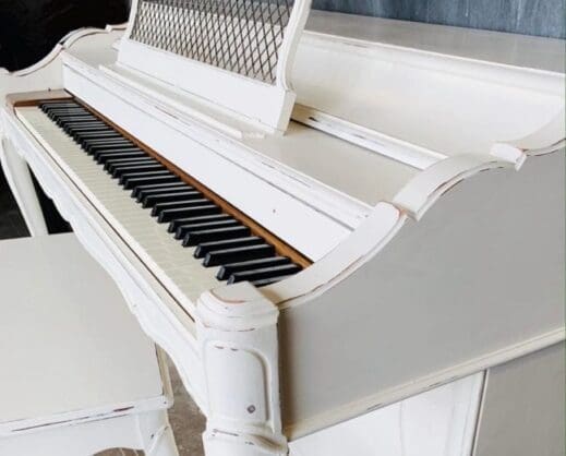 large wooden piano painted in off white clay furniture paint