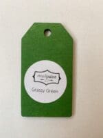 Small wooden tag hand painted with bright green clay furniture paint