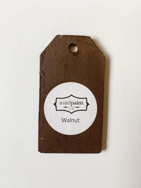 Small wooden tag hand painted with dark brown clay furniture paint