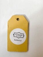 Small wooden tag hand painted with dark yellow clay furniture paint