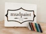 mudpaint clay furniture paint branded sign sitting on an easel with a white backdrop