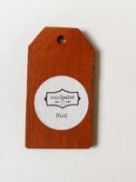 Small wooden tag hand painted with orange brown clay furniture paint