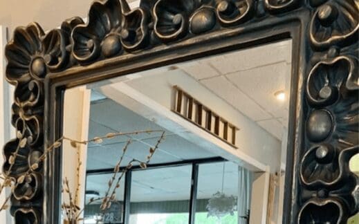 gold metallic wax distressed over just black clay furniture paint on a mirror frame