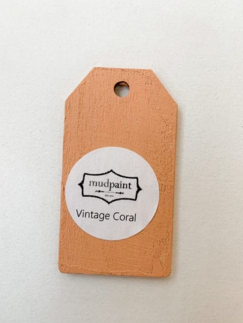 Small wooden tag hand painted with orange clay furniture paint